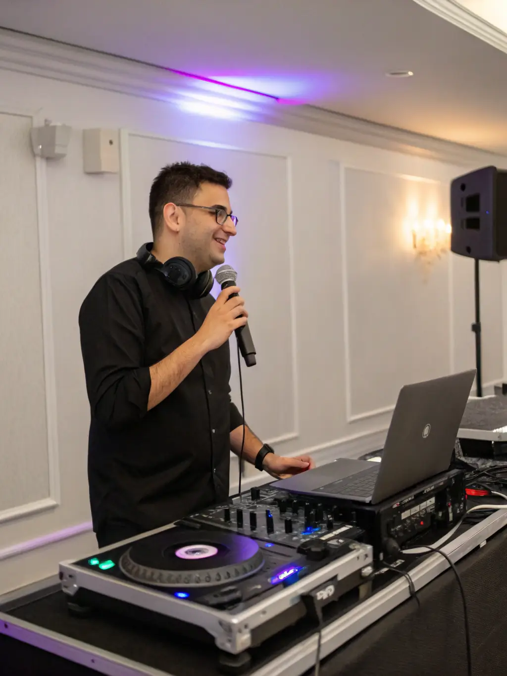 DJ performing with a custom light show at a private event, highlighting the personalized and unique experience.